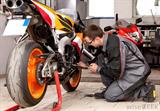 mechanic-fixing-motorcycle-engine.jpg